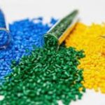 Polymers - Colorful polymer granules in blue, green, and yellow spilling out of test tubes